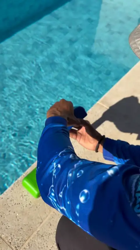 Alisson de uniforme medindo a água com o kit de teste